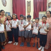 All smiles as the International Talent Olympiad of Primary Section pose with their medals and report cards with Principal Madam and Senior HM madam