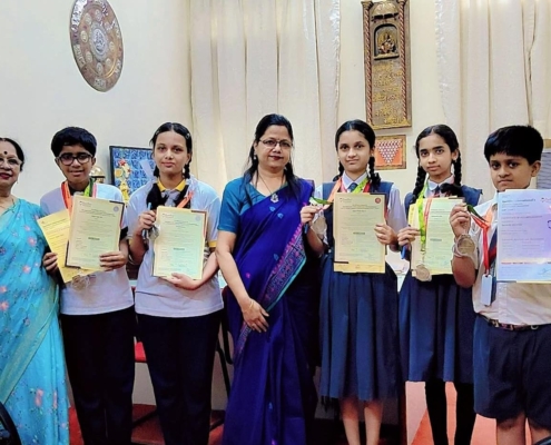 Winners of the Indian Talent Olympiad displaying their medals and certificates